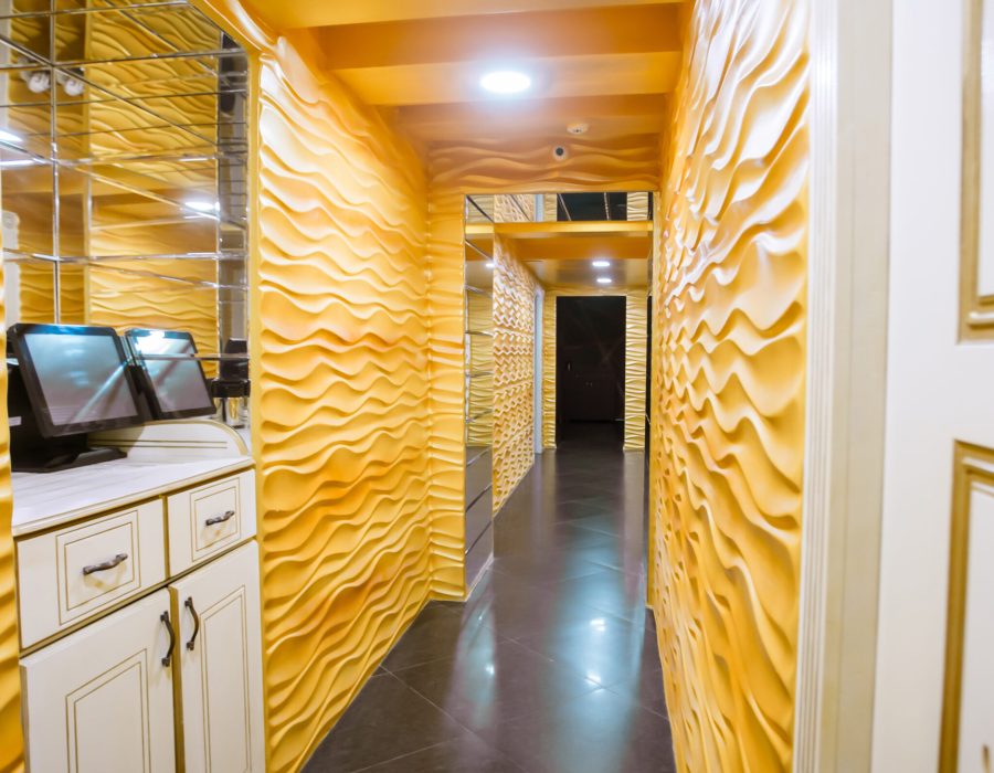 long corridor with yellow walls and ceiling white doors